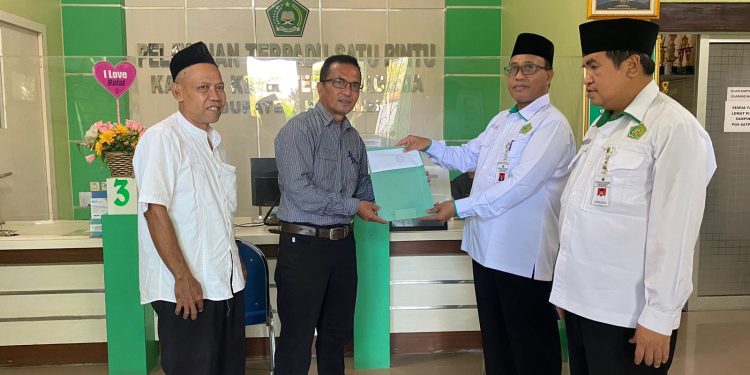 Kepala Kantor Kementerian Agama Kabupaten Kebumen Suarno saat menyerahkan bantuan untuk pembangunan Mushola Syekh Umar di ruang PTSP, Senin 10 Februari 2025.